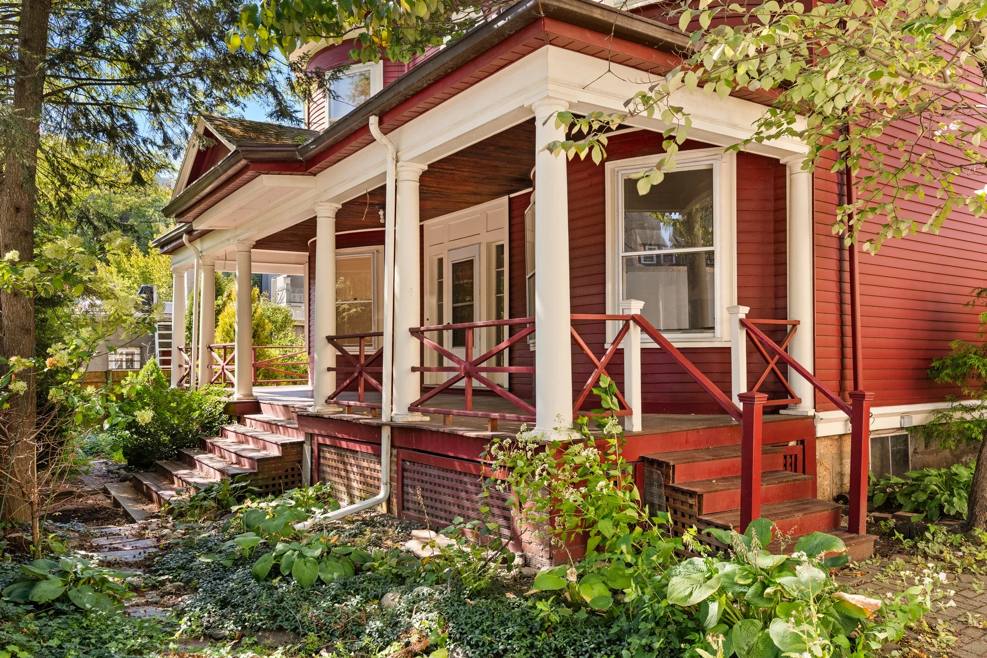 Existing red clapboard exterior and covered front porch of the Victorian at 62 Fuller Street before renovation