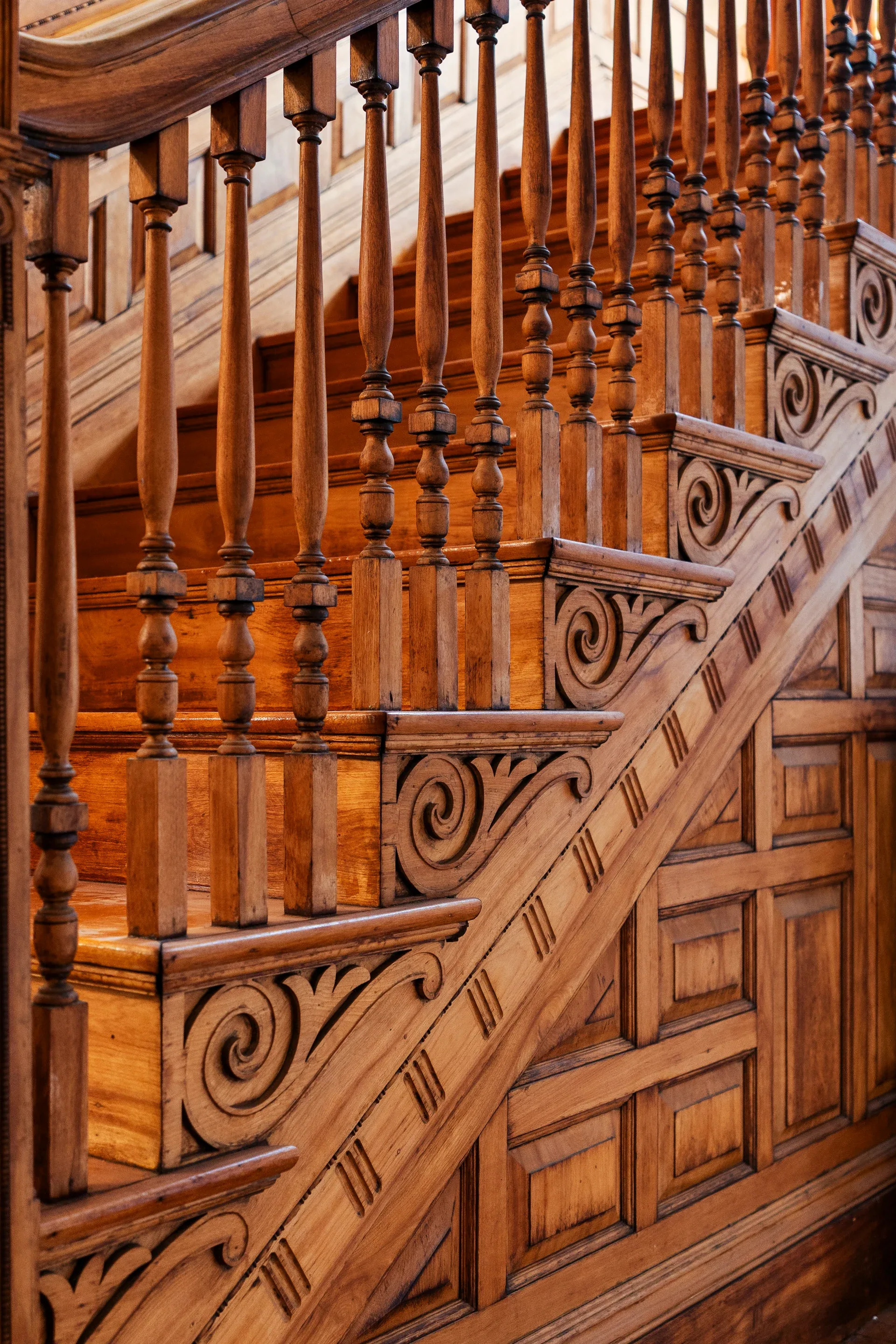 Close view of the original carved wood balustrade, turned spindles, and paneled stair at 62 Fuller Street before renovation