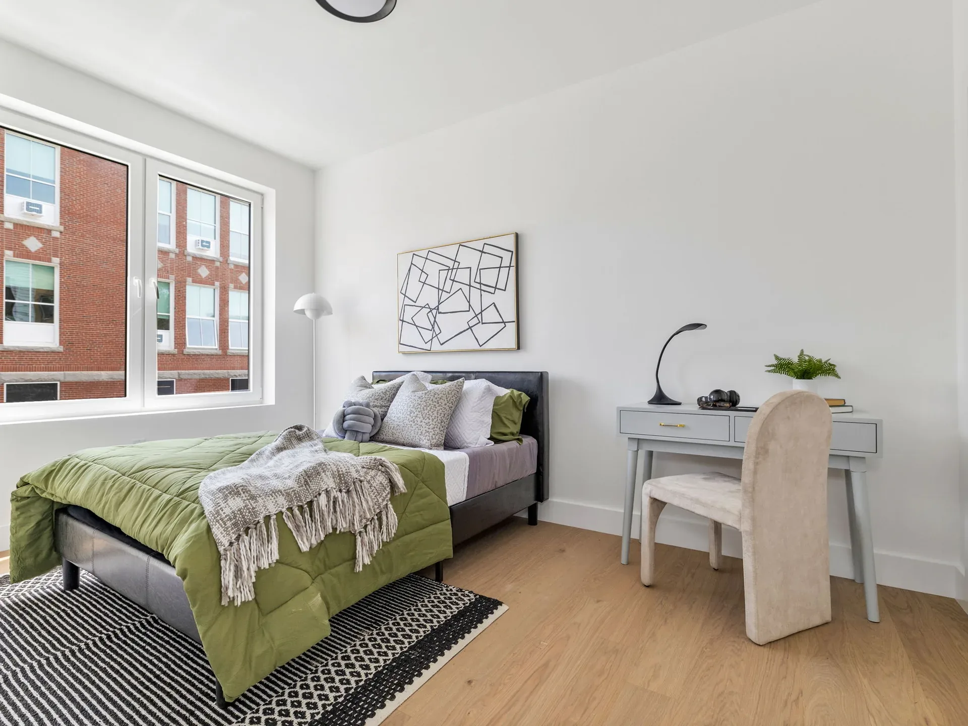 Staged bedroom with neighborhood views